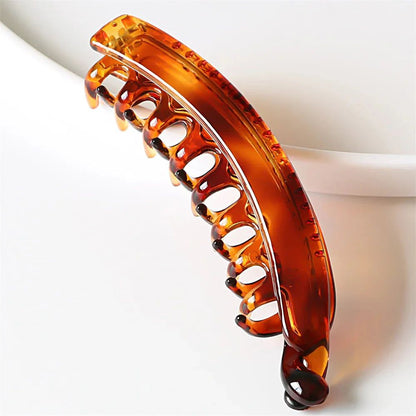 A close-up of the Miccelli Luxe Frosted Solid Color Banana Hair Clip, a stylish plastic hair claw with curved prongs and a glossy finish—an essential accessory for any collection.